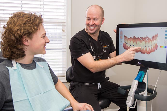 Dr. James Brannen happily discusses photos with patient at Legacy Hill Dentistry in Smyrna, TN